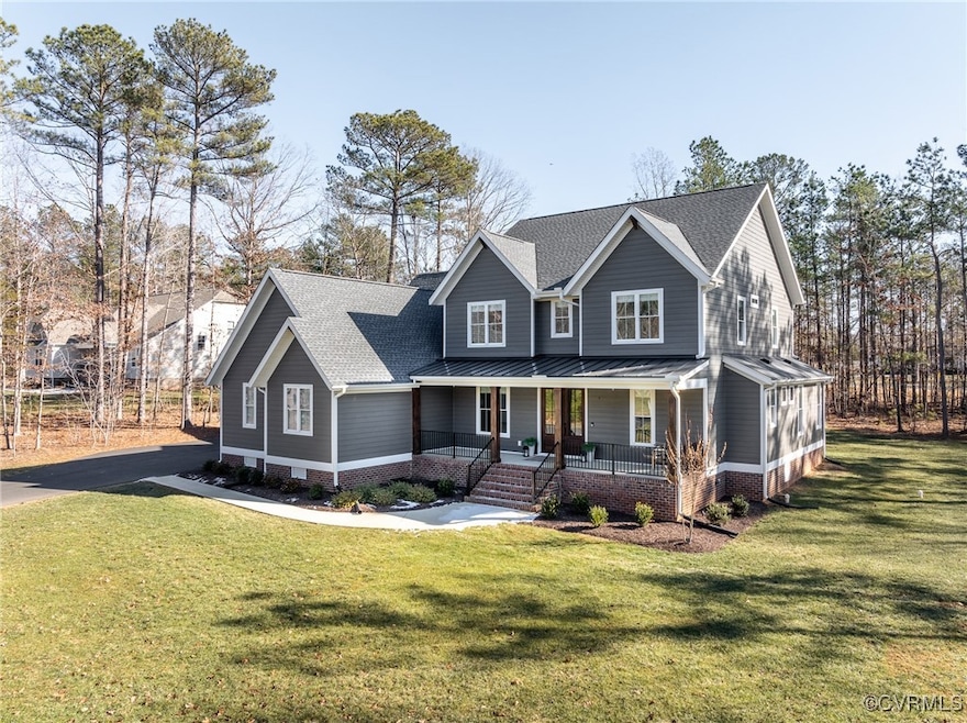 Front of house with yard and walk up porch.