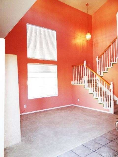 Living Room with Vaulted Ceilings and New Paint and Carpet