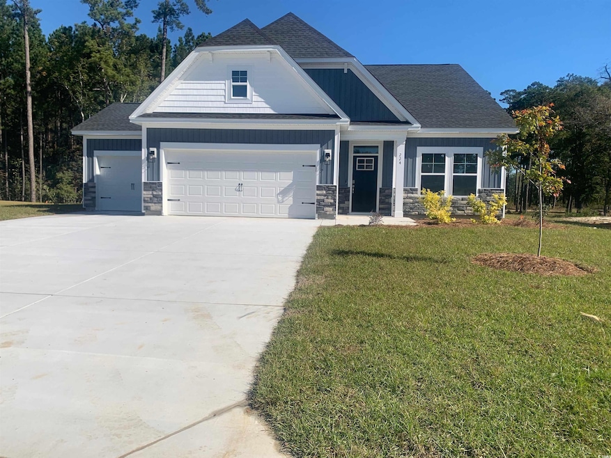Craftsman-style home featuring stone siding, a front lawn, roof with shingles, concrete driveway, and an attached garage