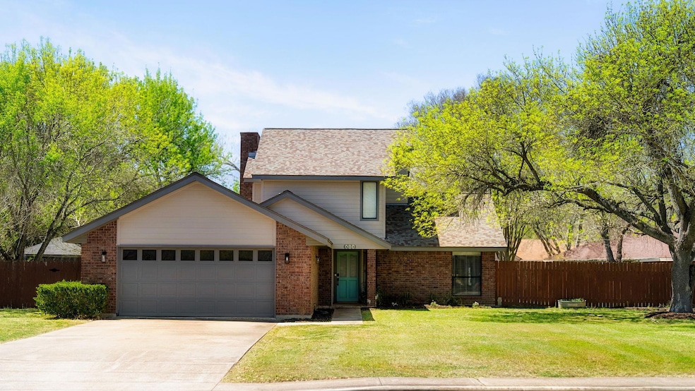 Traditional-style home with a garage, driveway, a