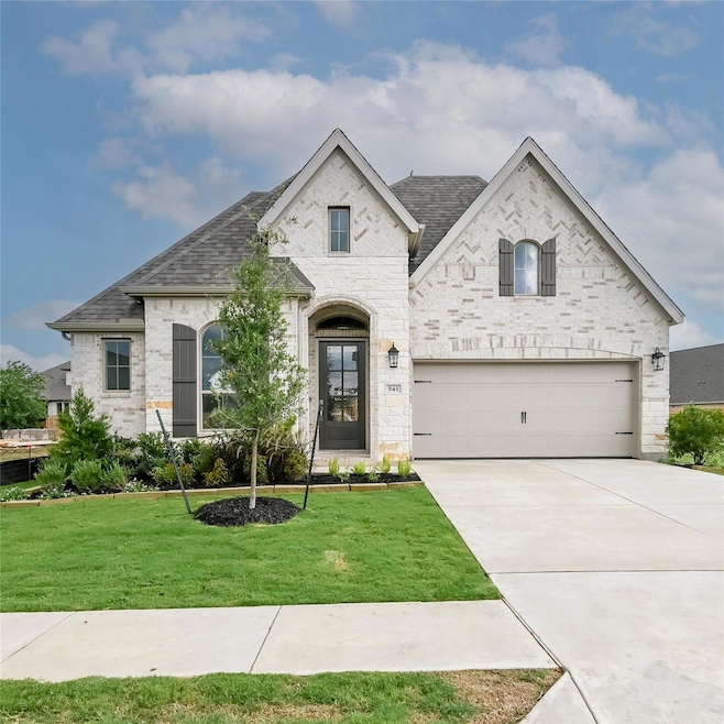 French country inspired facade featuring concrete