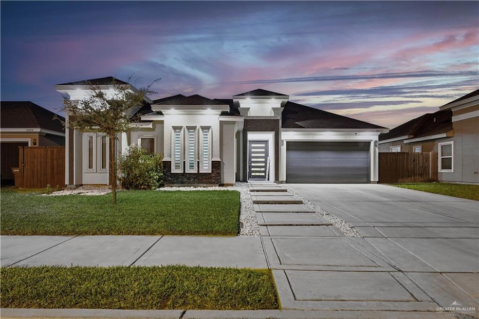 View of front of home with concrete driveway, stucco siding, stone siding, and a garage