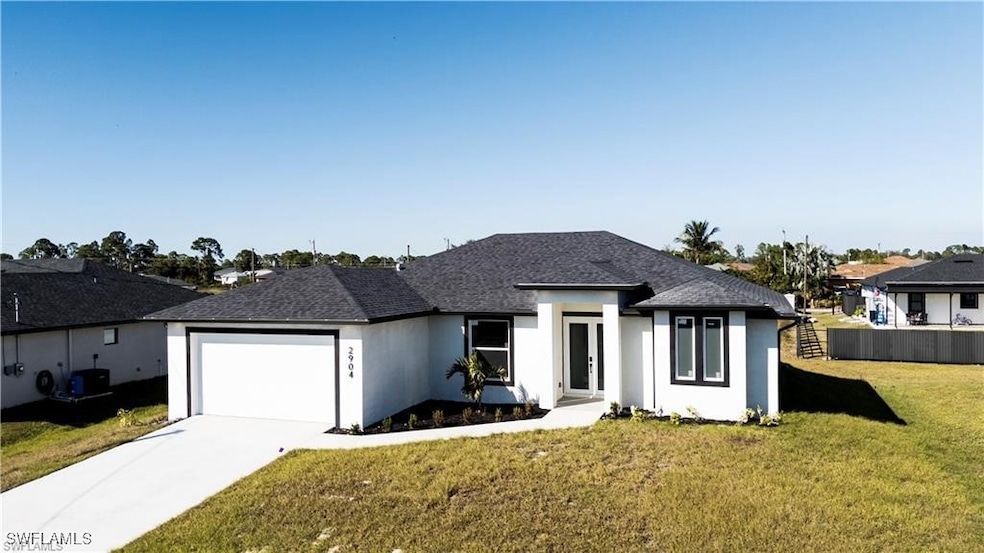 View of front of house featuring a garage, concret