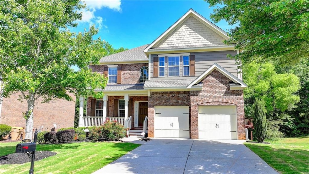 Craftsman inspired home featuring a garage, a porc