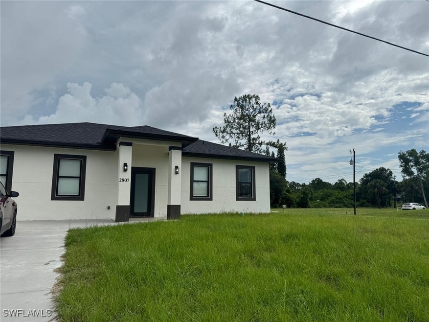 Prairie-style home featuring stucco siding and roo