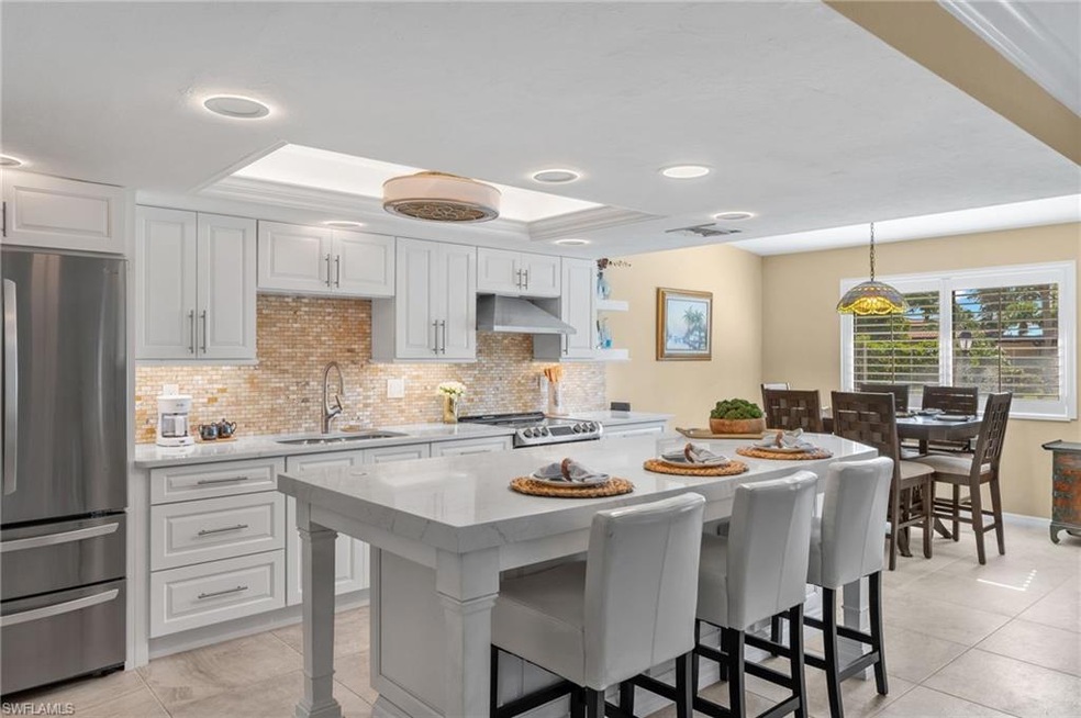 Kitchen featuring white cabinets, sink, stainless 