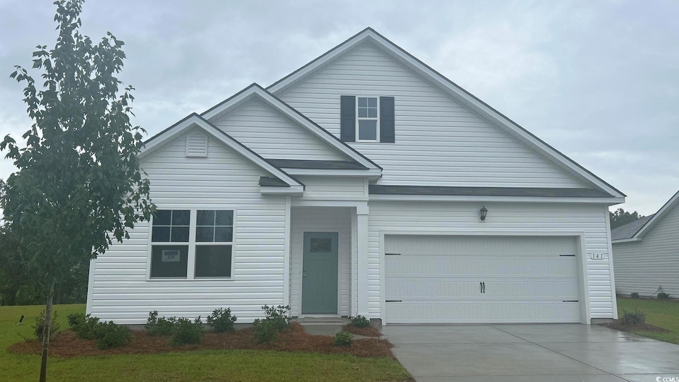 Traditional home with concrete driveway and a garage