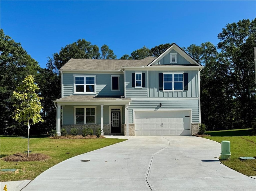 Craftsman house with brick siding, a porch, a front yard, and driveway