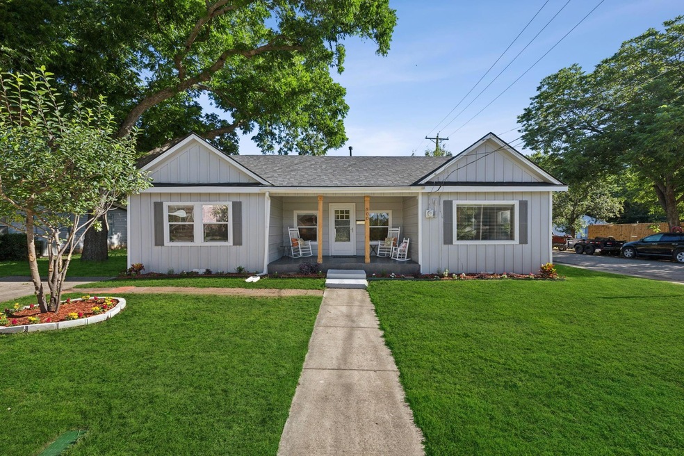 Single story home featuring a front yard and cover