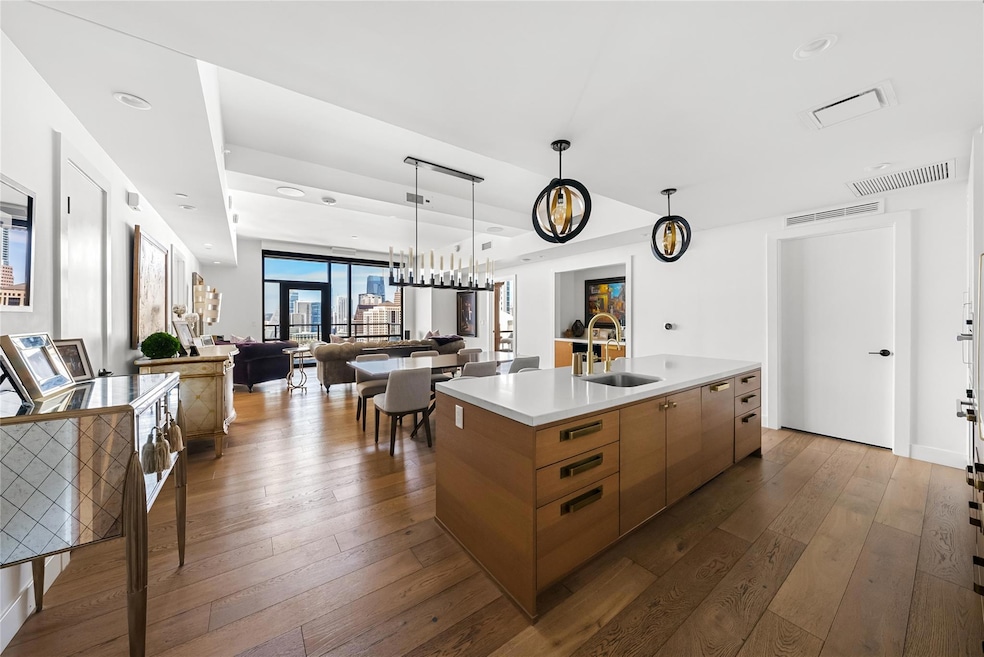 Kitchen with dark wood-type flooring, visible ven