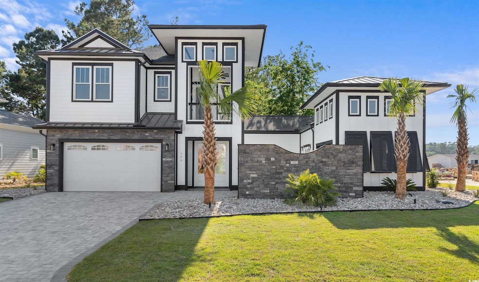 View of front of property with a garage, a standin