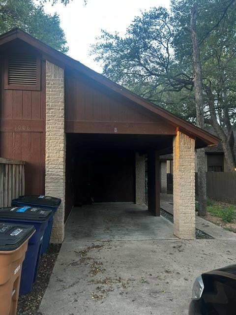 View of side of property with concrete driveway