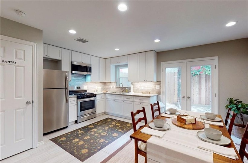 Kitchen with stainless steel appliances, a sink, f