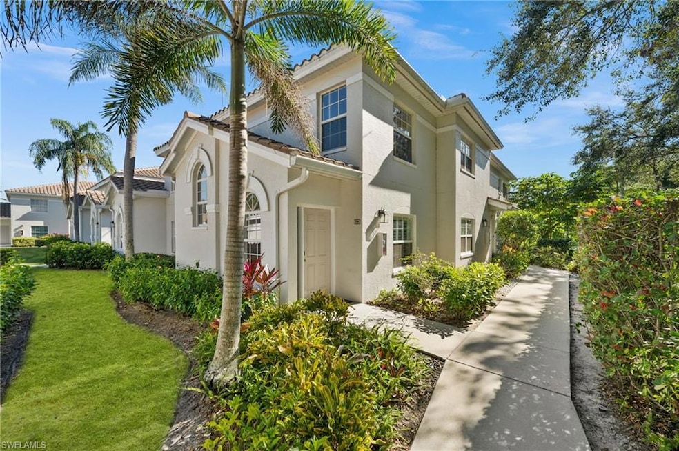 View of front of home featuring stucco siding and a front lawn