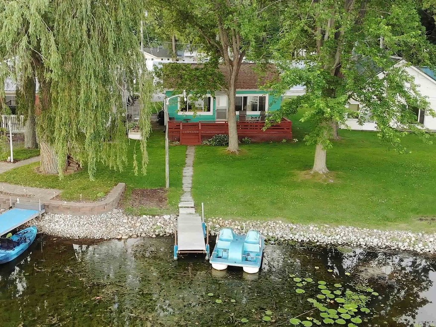 Aerial view of home and lakefront.