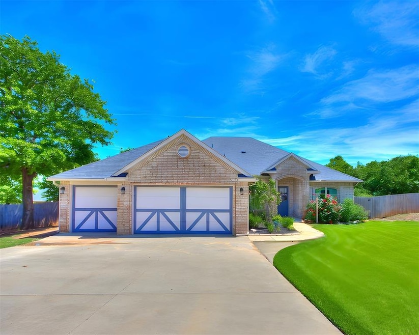 Single story home with driveway, brick siding, an 