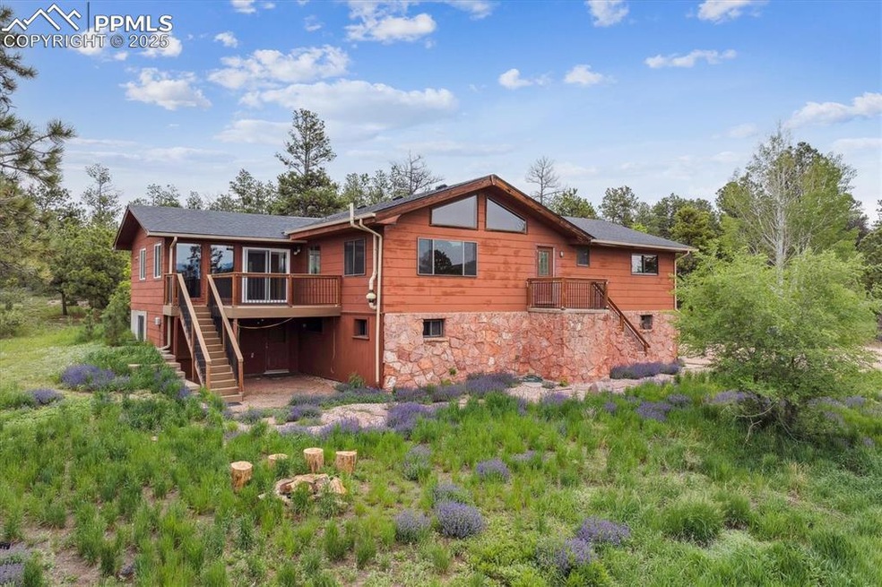 Back of property with stairway and a deck