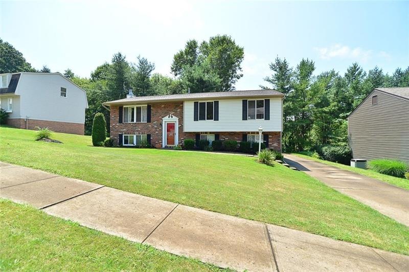 Large partial brick split entry with level drivewa