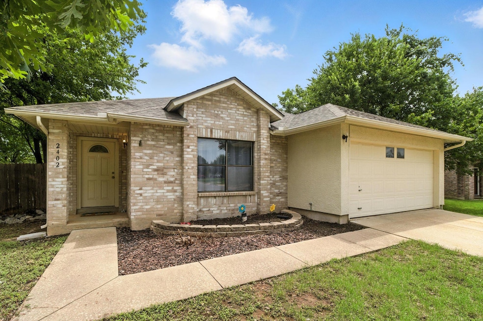 Ranch-style home featuring concrete driveway, a g