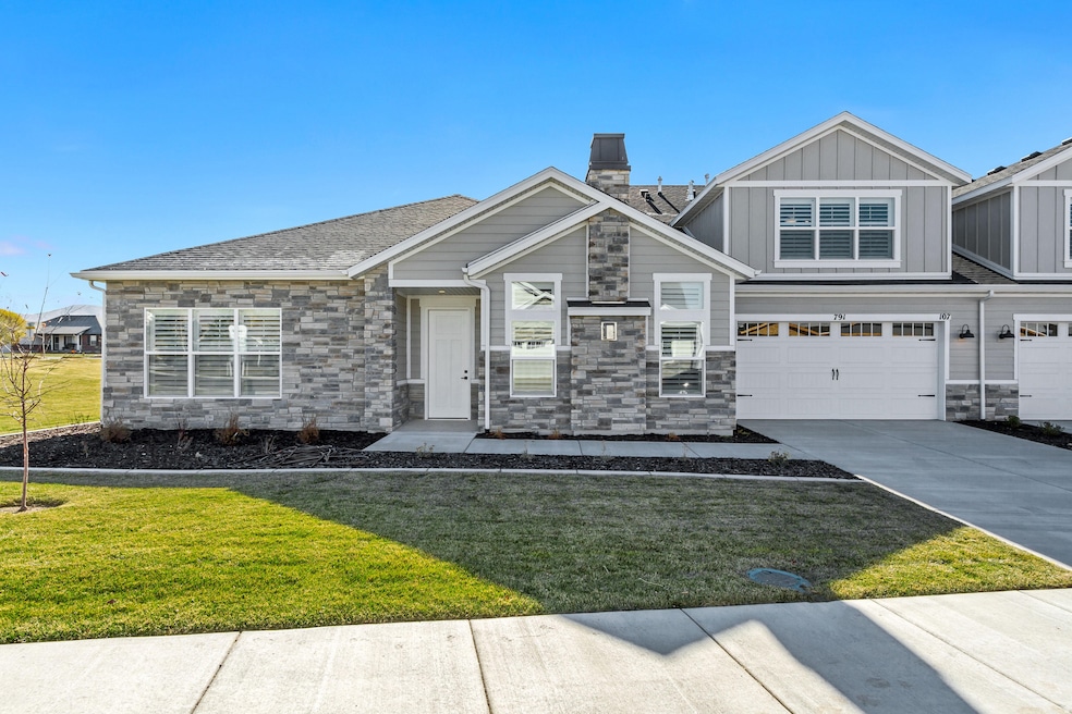 Craftsman house with stone siding, a front lawn, and driveway