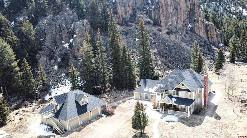 Birds eye view of property with a view of trees