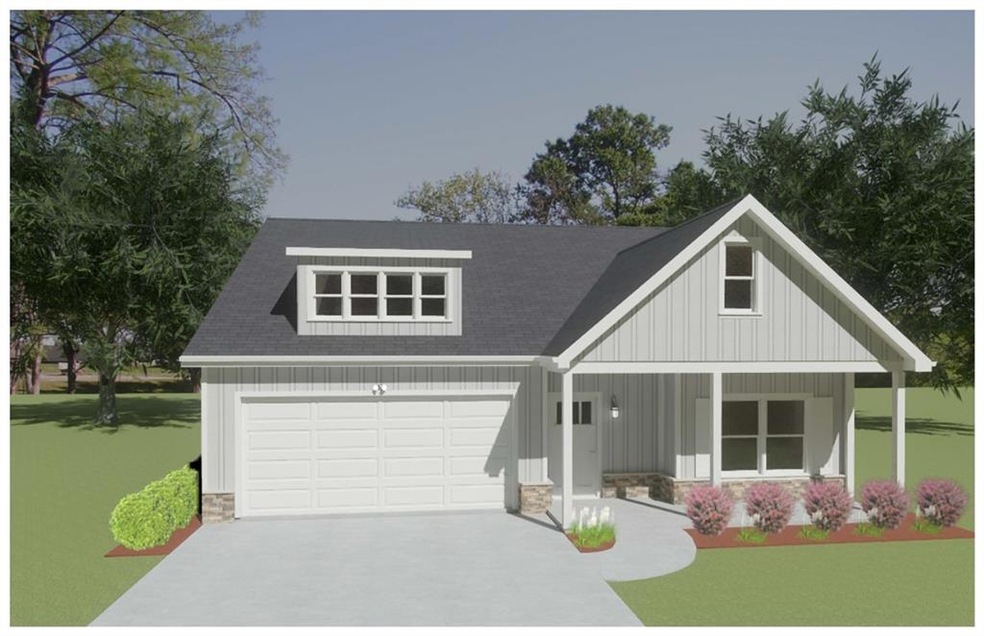 View of front of property with a front yard, a garage, and covered porch
