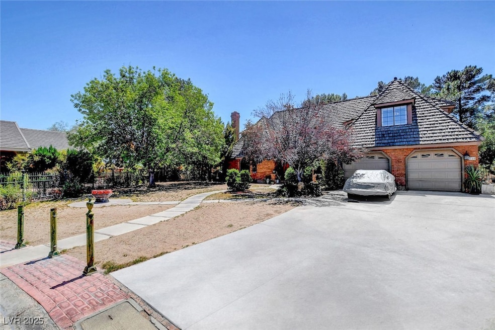 View of front of home with concrete driveway, fenc