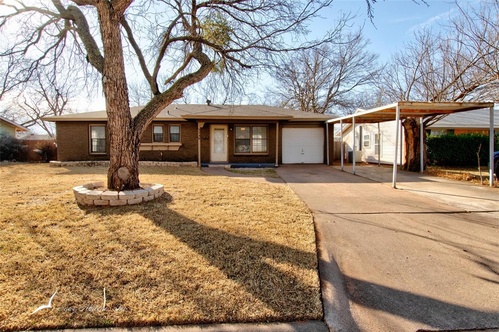 Single story home with a front lawn, a garage, and