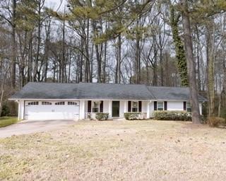 Ranch-style home with a garage and concrete drivew
