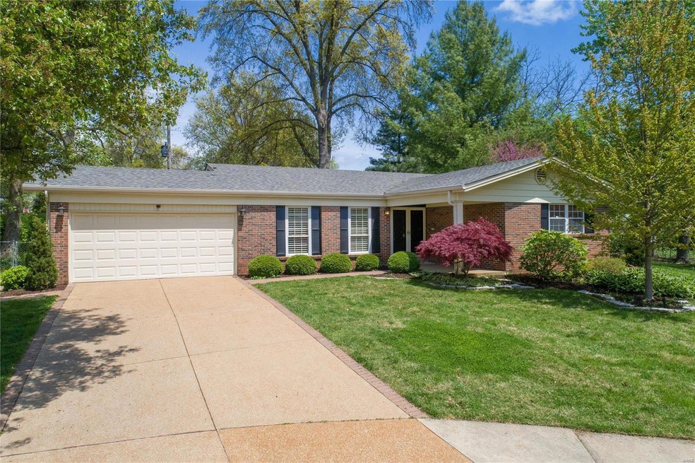 4789 Stanhope Dr., aggregate concrete driveway with paver brick border