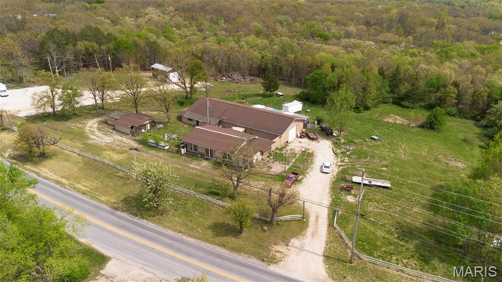 Birds eye view of property with a view of trees
