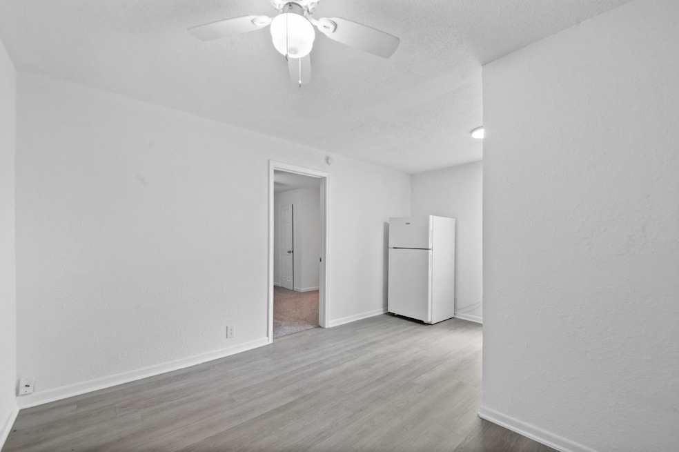 This photo shows the exterior of a white brick hom
