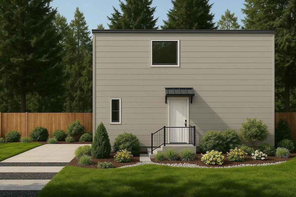 Back of property with a lawn and fence