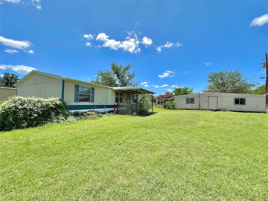 Front of home and garage with large lot.