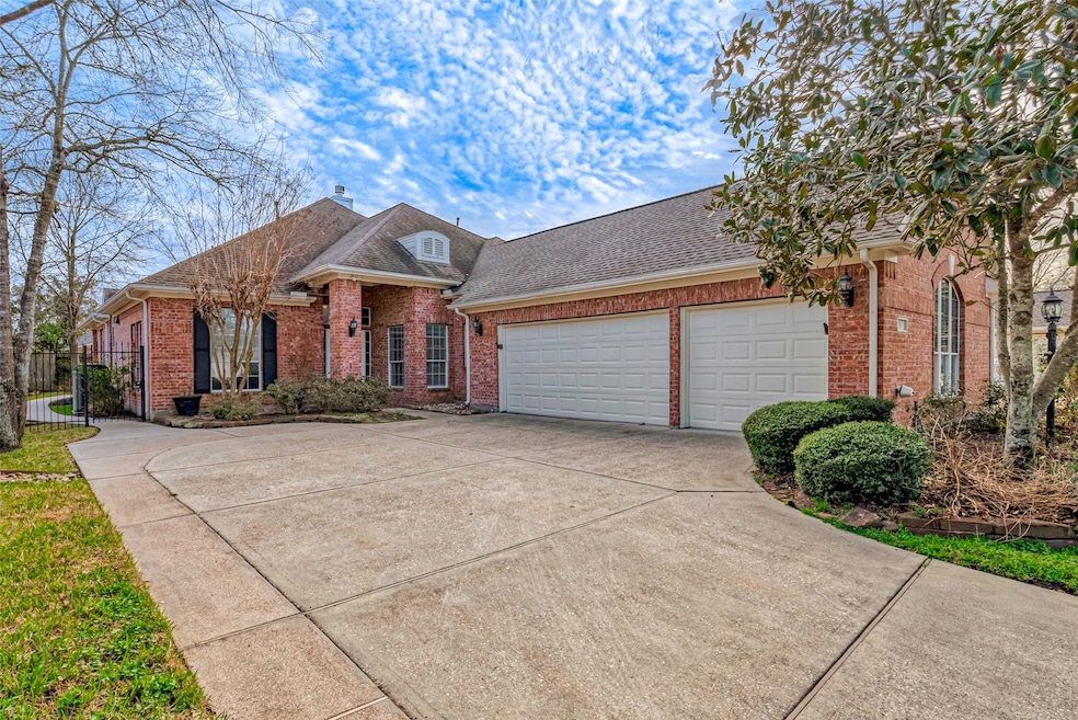 19 Pearl Garden Ct. features a rare full three-car garage, rock lined landscaping beds, exterior coach lights, gutters, and covered entryway.