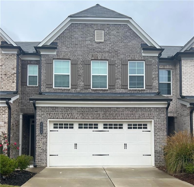View of front of property featuring concrete drive