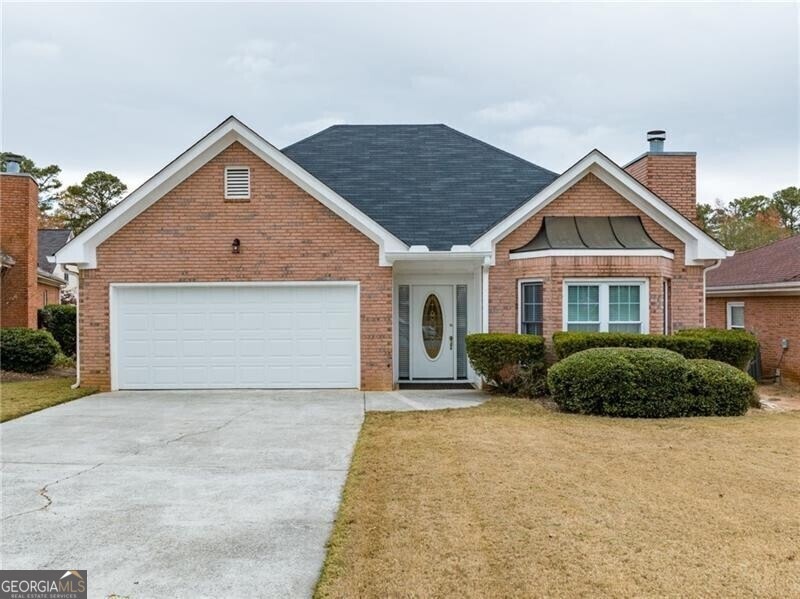 View of front of property with a garage and a fron