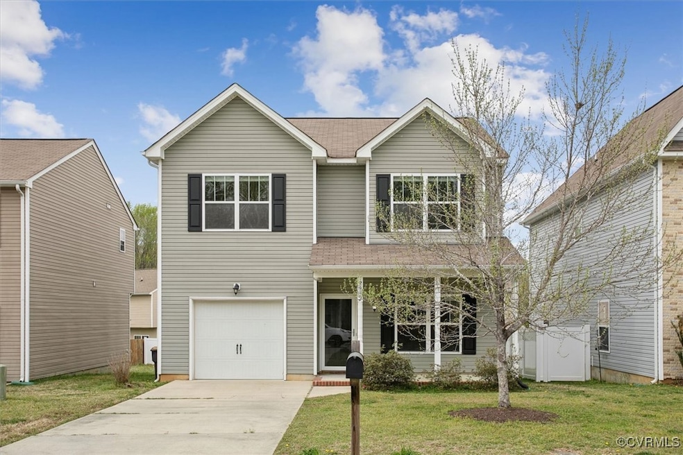 Traditional-style home featuring an attached garage, front porch.