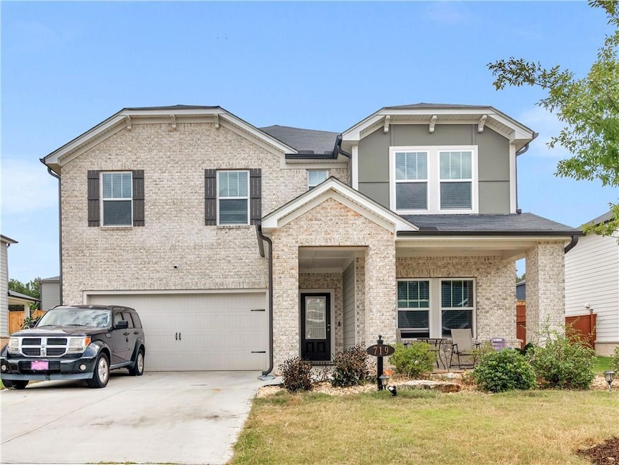 View of front of property with a front lawn, a gar
