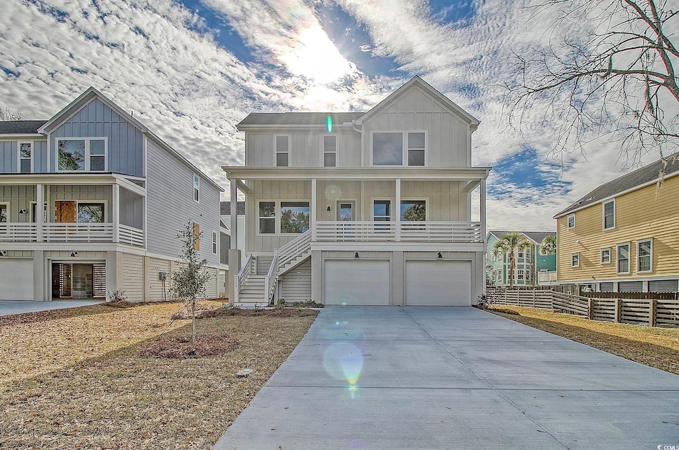 Beach home featuring a garage and a porch