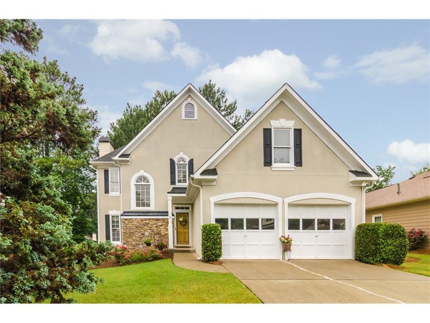 Nestled on a flat lot in swim/tennis neighborhood,