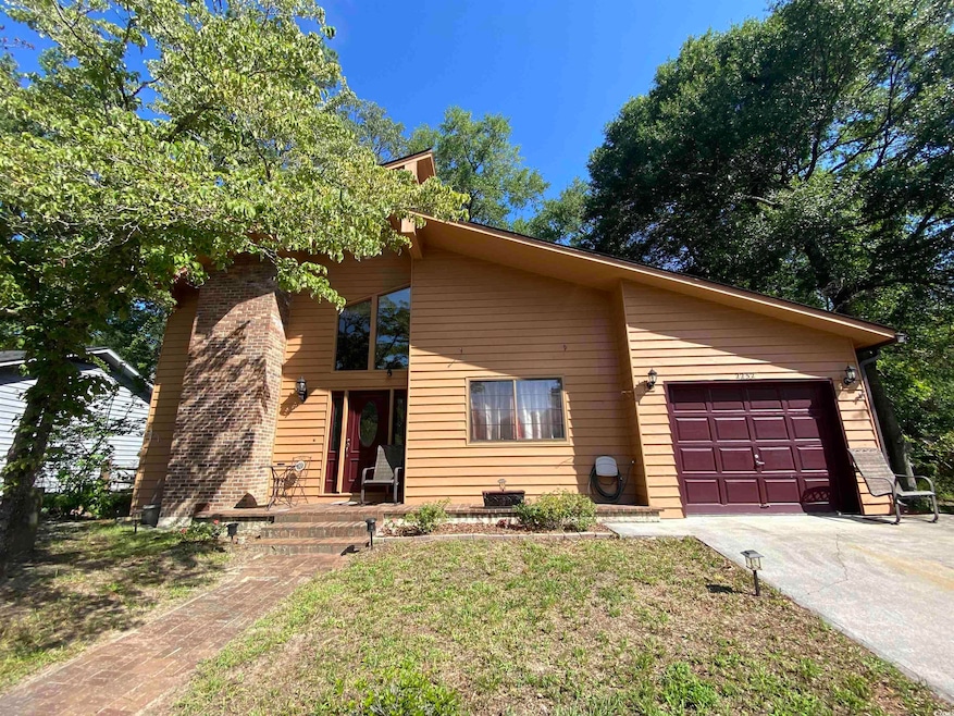 Mid-century inspired home featuring driveway and an attached garage