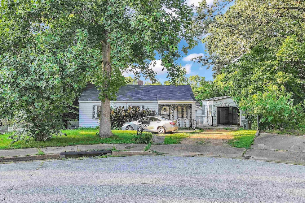 View of front of house featuring a chimney and a carport