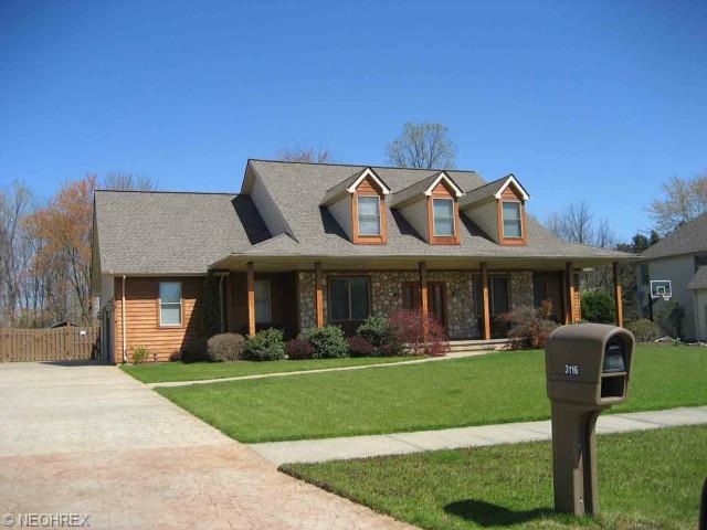 Stone, cedar and vinyl Cape Cod with first floor m