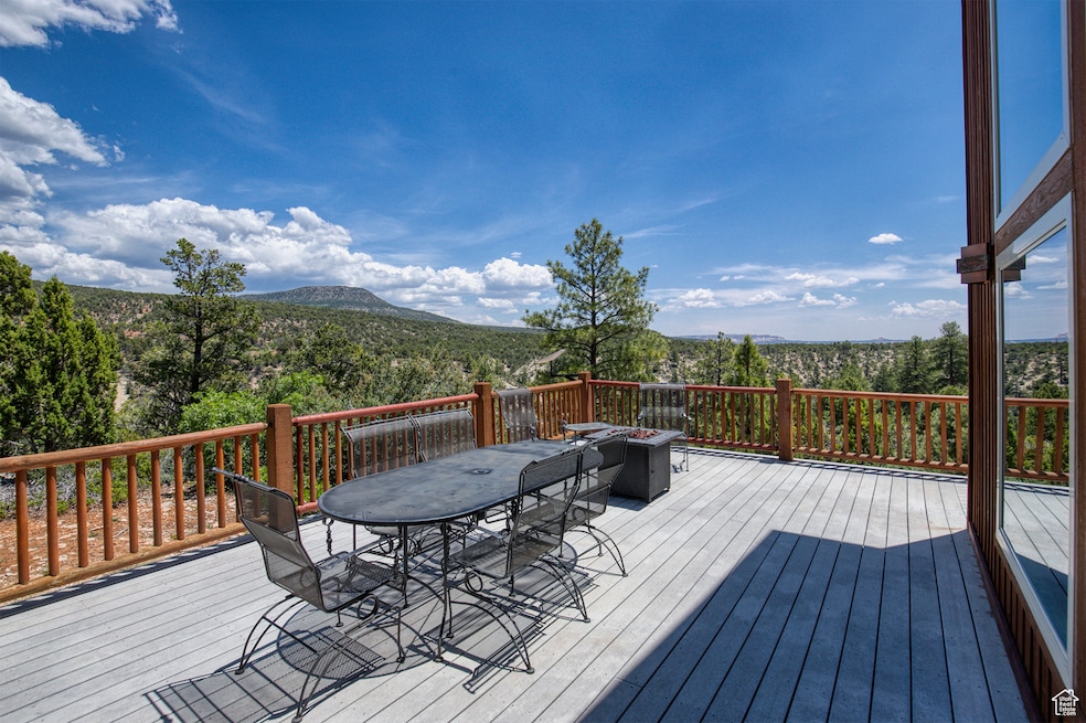Wooden terrace featuring outdoor dining area and a mountain view