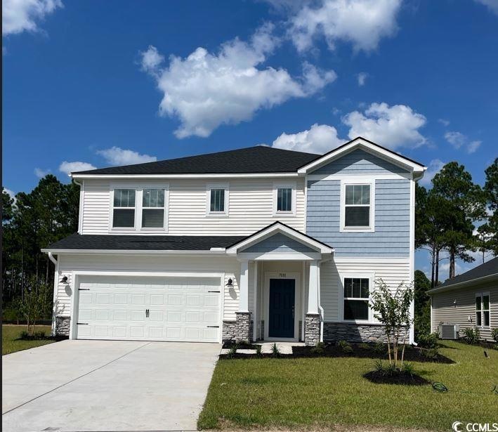 View of front of house featuring a garage, a front