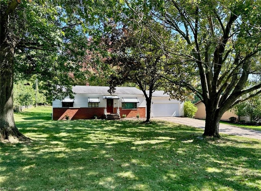 View of front facade with garage and a front lawn