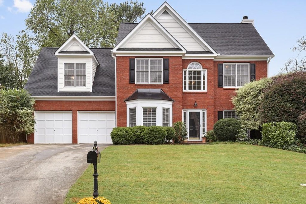 Stately curb appeal enhanced by brick facade, new 