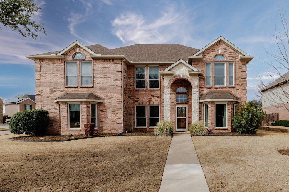 Traditional-style home with roof with shingles and
