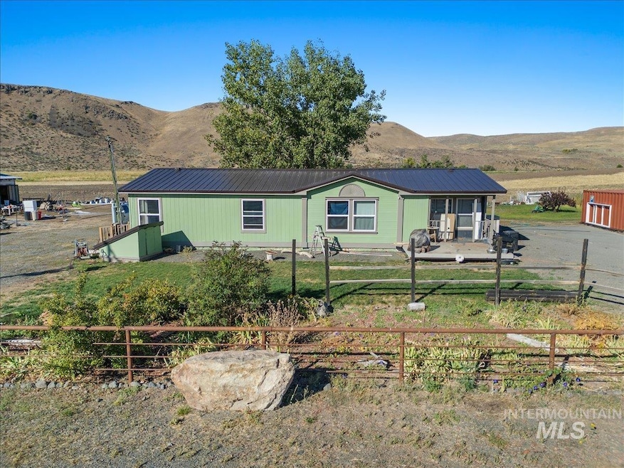 Rear view of property featuring a metal roof and a mountain view